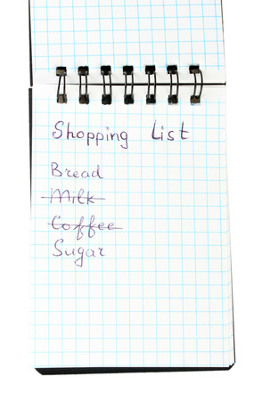 shopping list in a notebook on white background close-upの写真素材
