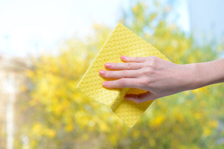 Hands with  napkin cleaning  window