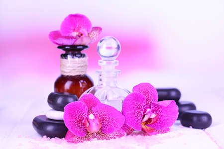 Beautiful spa setting with orchid on white wooden table on bright backgroundの写真素材