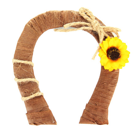 Decorative horseshoe of straw with sunflower, isolated on whiteの写真素材