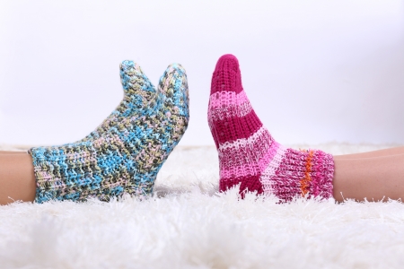 Legs in colorful socks on white carpet backgroundの写真素材