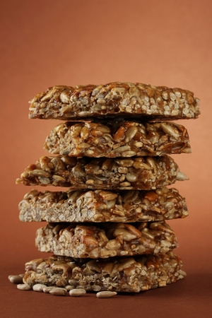 tasty sweets (kozinaki), on brown backgroundの写真素材