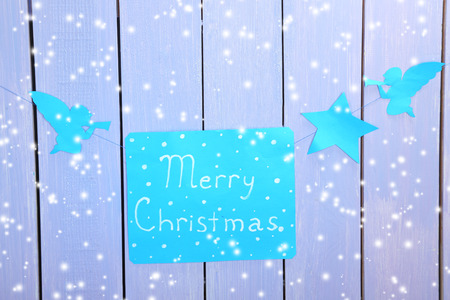 Signboard with words Merry Christmas on wooden table background close-upの写真素材