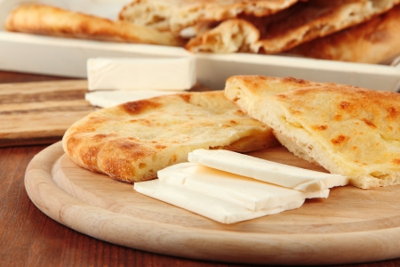 Pita breads with cheese on wooden stands close upの写真素材