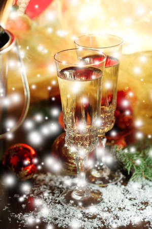 Composition with Christmas decorations and two champagne glasses, on bright backgroundの写真素材