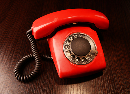 Red retro telephone,on dark backgroundの写真素材