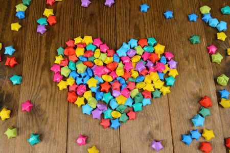 Paper stars with dreams on wooden background