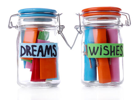Dreams written on color  rolled paper in glass jar, isolated on whiteの写真素材