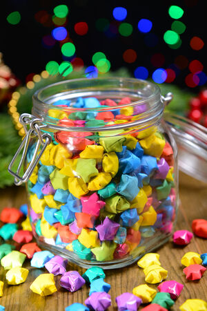 Paper stars with dreams on table on dark backgroundの写真素材