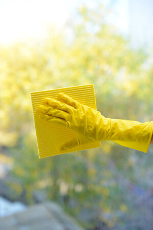 Hands with  napkin cleaning  windowの写真素材
