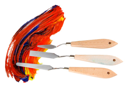 Painting palette knife with paint isolated on whiteの写真素材