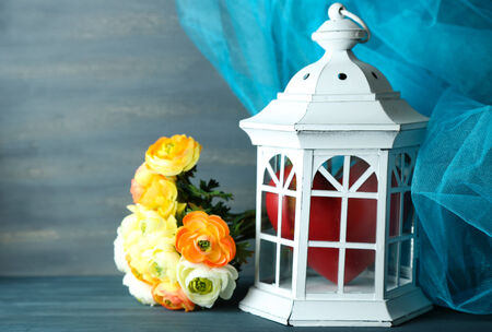 Heart in cage on color wooden backgroundの写真素材