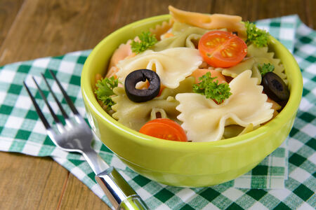 Delicious pasta with tomatoes on plate on table close-upの写真素材