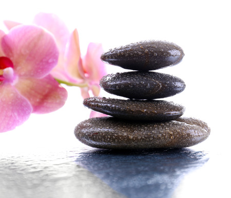 Composition with beautiful blooming orchid with water drops and spa stones, on light の写真素材