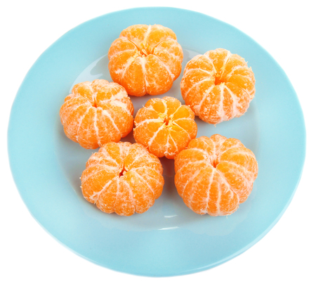 Ripe sweet tangerines on color plate, isolated on whiteの写真素材