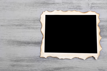 Blank old photo on color wooden background