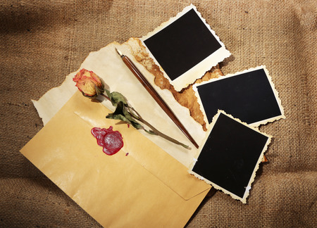 Composition with blank old photos, paper, letters on sackcloth 