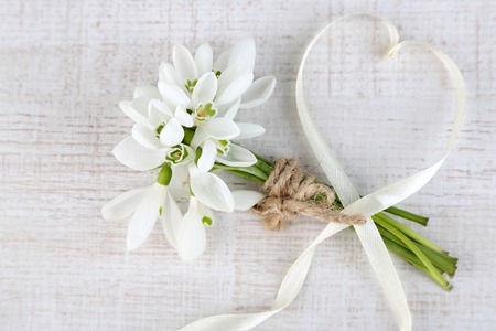 Bouquet of beautiful snowdrops on wooden table の写真素材