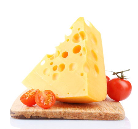 Piece of cheese and tomatoes, on wooden board, isolated on whiteの写真素材