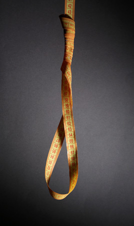 Tape measure noose on grey background - diet concept