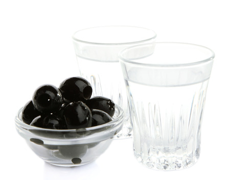 Composition with  two glasses  of vodka, and black olives, isolated on whiteの写真素材