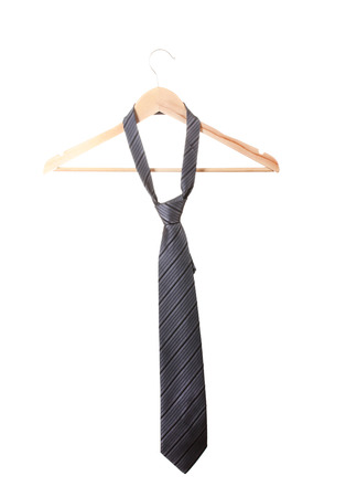Elegant grey tie on wooden hanger isolated on whiteの写真素材