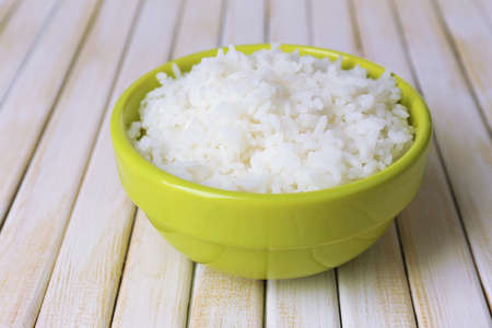 Cooked rice in bowl on wooden backgroundの写真素材