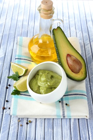 Fresh guacamole in bowl on wooden tableの写真素材
