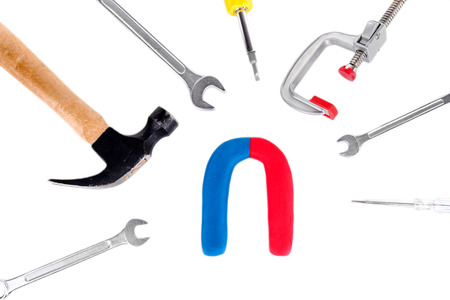 Horseshoe magnet with tools isolated on whiteの写真素材