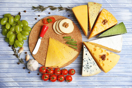 Different Italian cheese on wooden table