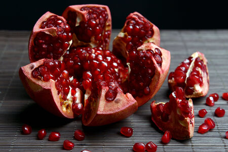 Ripe pomegranates on table close-upの写真素材