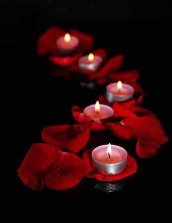 Beautiful rose petals with candle, on dark backgroundの写真素材