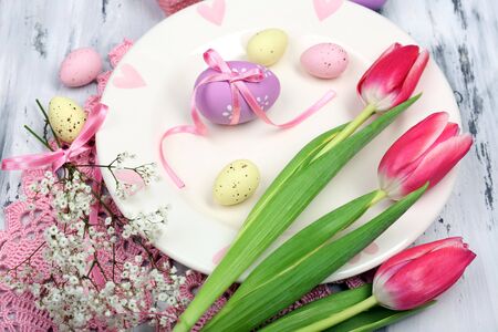 Easter table setting with tulips and eggs