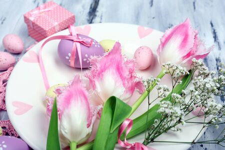 Easter table setting with tulips and eggs