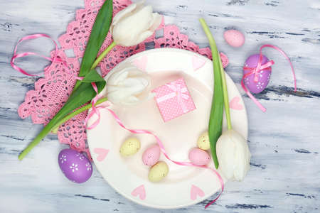 Easter table setting with tulips and eggs