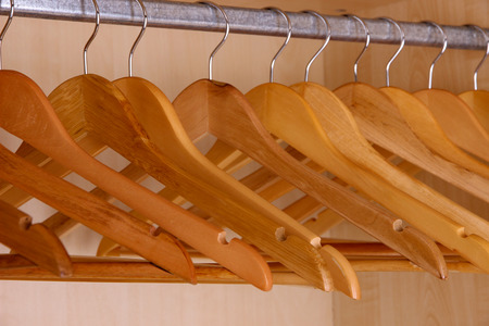 Wooden hangers in wardrobeの写真素材
