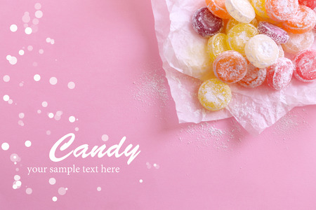 Sweet  multicolor candies on paper, on color の写真素材