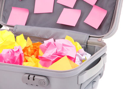 Open suitcase with paper stickers isolated on whiteの写真素材