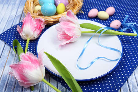 Easter table setting with tulips and eggs