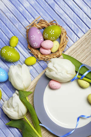 Easter table setting with tulips and eggs