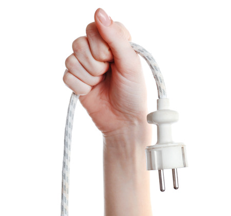 Hand holding electric plug isolated on white 