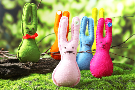 Funny handmade Easter rabbits on green grassの写真素材