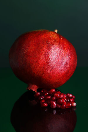 Ripe pomegranate on dark color  backgroundの写真素材