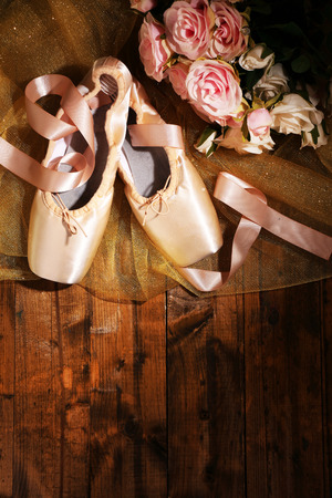Ballet pointe shoes on wooden backgroundの写真素材
