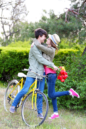 Young couple with bicycle in parkの写真素材