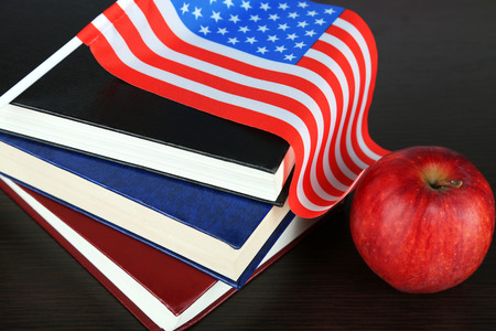 Composition of  American flag, books and apple  on wooden table backgroundの写真素材