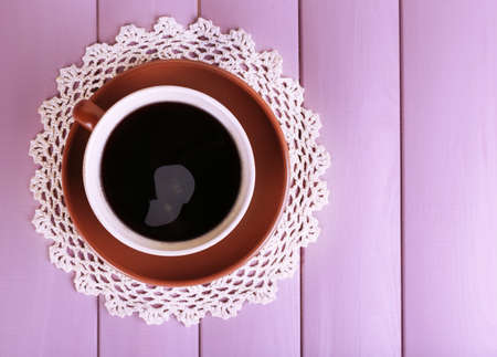 Cup of strong coffee on color wooden backgroundの写真素材