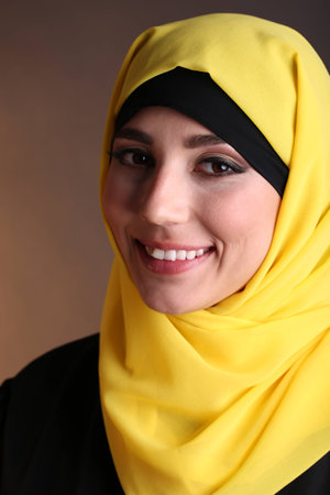Beautiful muslim arabic woman on dark color backgroundの写真素材