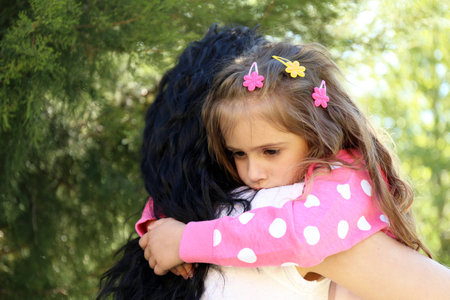 Happy mom and daughter. Walk in the green parkの写真素材