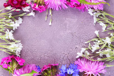 Bright wildflowers on color wooden backgroundの写真素材